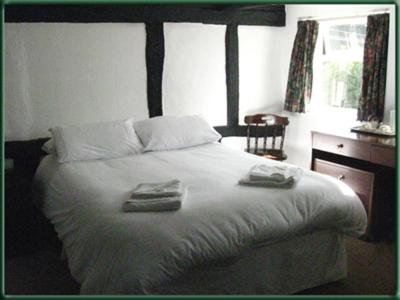 a bedroom with a bed with two towels on it at The Bulls Head Inkberrow in Inkberrow