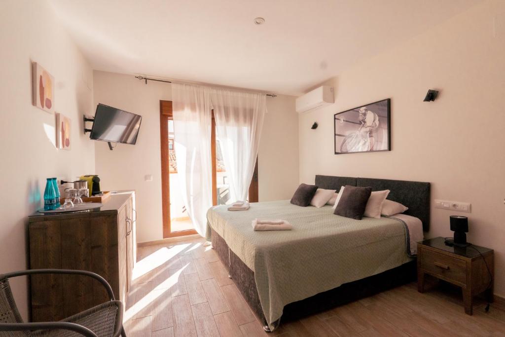 a bedroom with a bed and a large window at Blanca Boutique BnB in Jávea