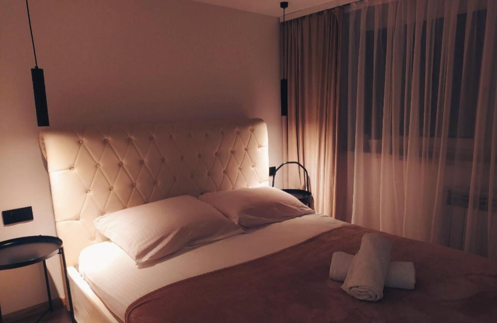 - une chambre avec un grand lit blanc et une grande tête de lit dans l'établissement Apartamenty w Pieninach, à Sromowce Wyżne