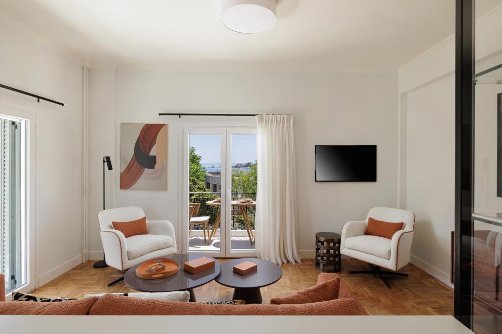 a living room with two chairs and a table at Vanda's Maison in Corfu Town