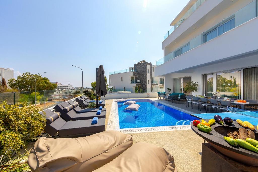 a villa with a swimming pool and a patio at Fig Tree Bay Residences 6 in Protaras