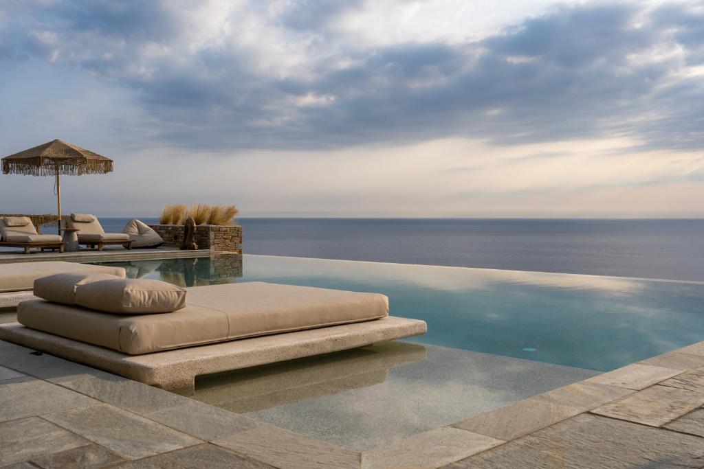 a swimming pool with a view of the ocean at Agapitos Villas & Guesthouses in Agios Ioannis Pelio