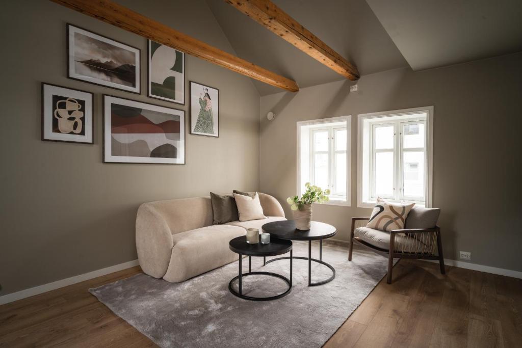 a living room with a couch and a table at Enter Viking Apartment Hotel in Tromsø