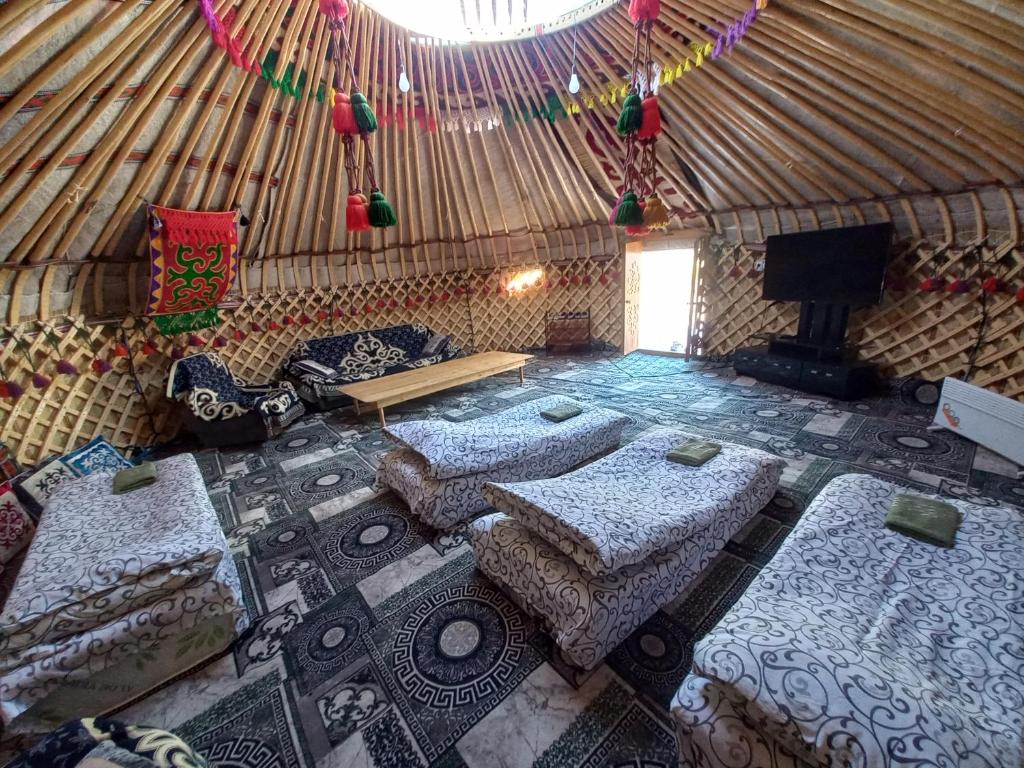 an aerial view of a yurt with beds and a fireplace at Karakol Yurt Village in Karakol