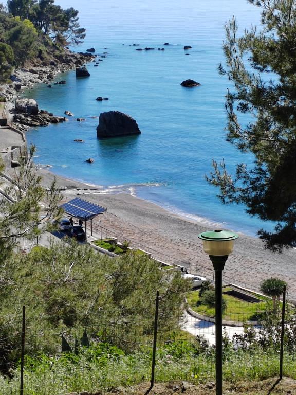a view of a beach with a light next to it at Villaglauca in Maratea