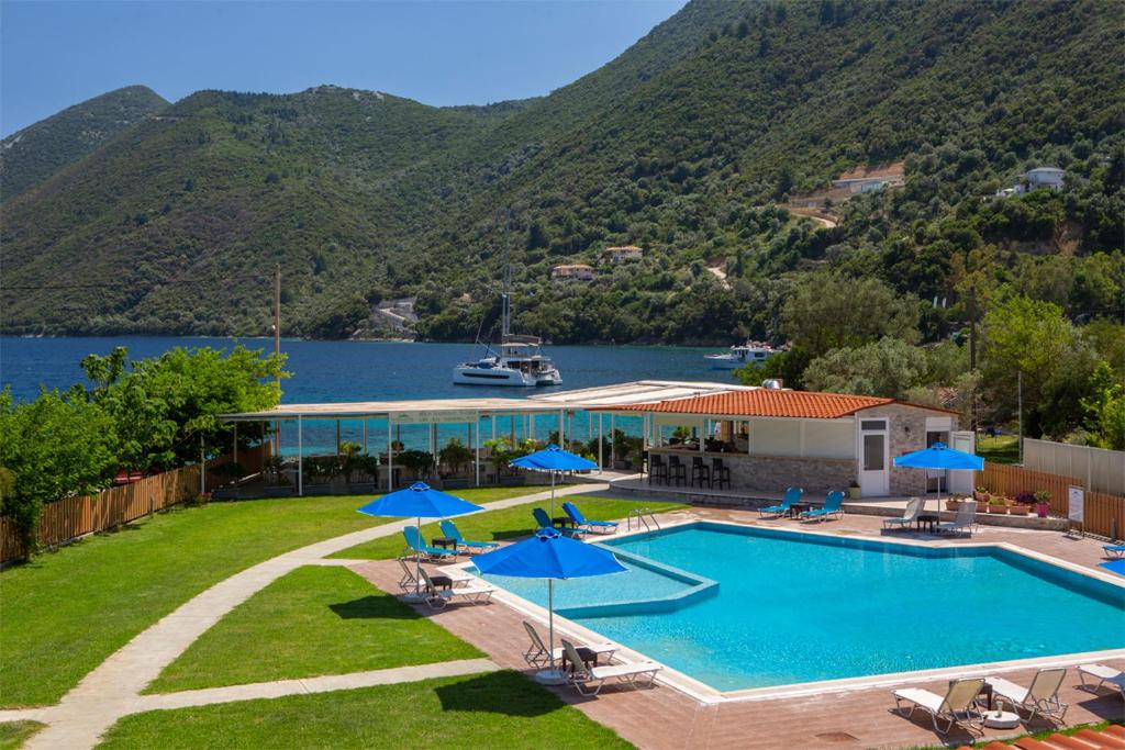a resort with a swimming pool and a lake at Menes Hotel in Yenion