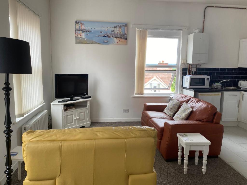 a living room with a couch and a chair at Old Co Op House -Forest of Dean in Bream