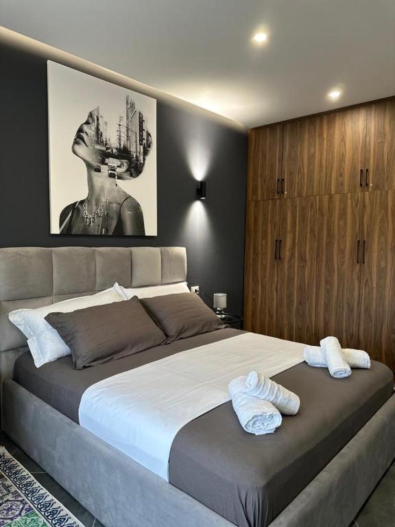 a bedroom with a large bed with two towels on it at Ermar Apartment 2 in Golem