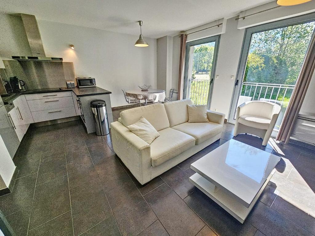 a living room with a couch and a table at Appartement 4-6 couchages in Aulus-les-Bains