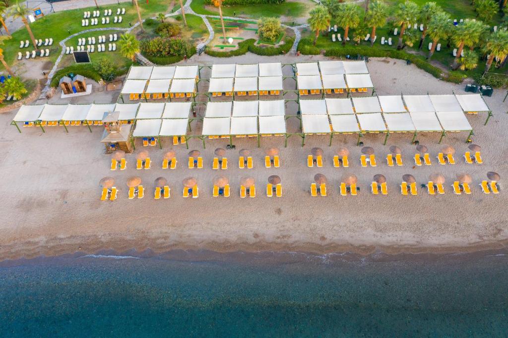 an aerial view of a beach with a row of buildings at Selectum Collection Bodrum in Akyarlar