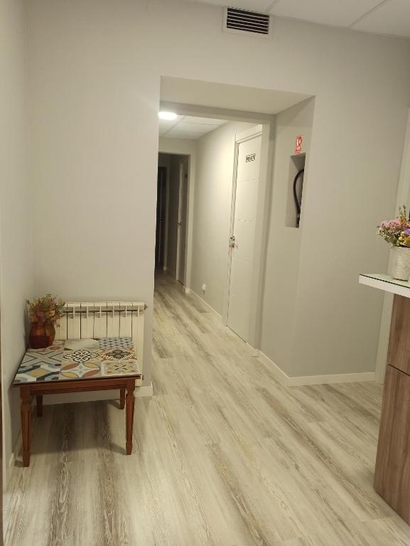 an empty room with a bench and a hallway at Hostal Ruta de Francia in Barcelona