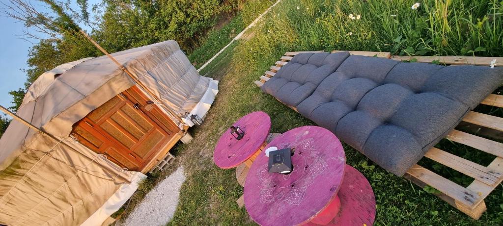 an overhead view of a couch and a table at Yourtes 6 personnes proche provins et disney in Bannost