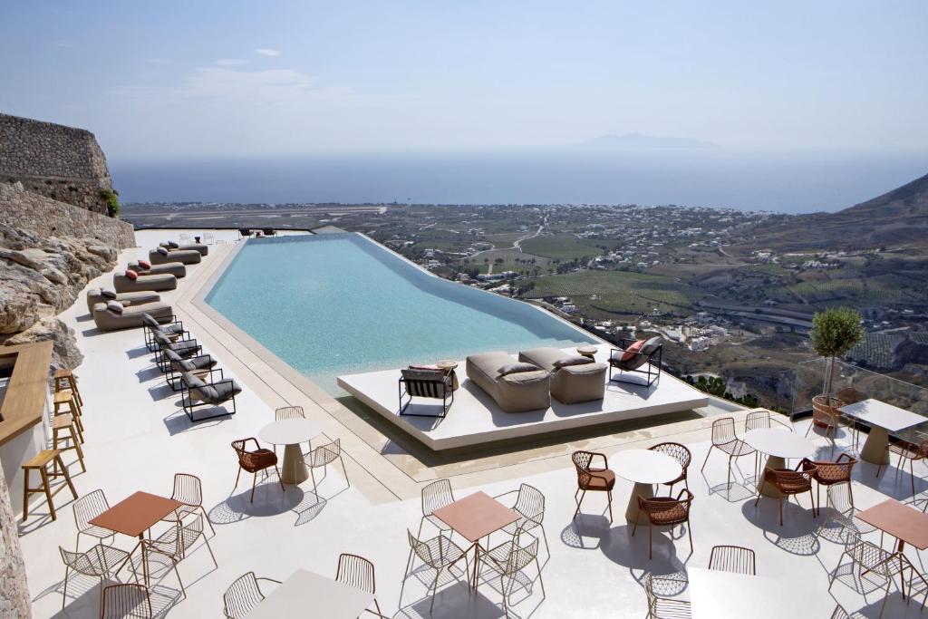 vista su una piscina con sedie e tavoli di Elessa Hotel a Pyrgos