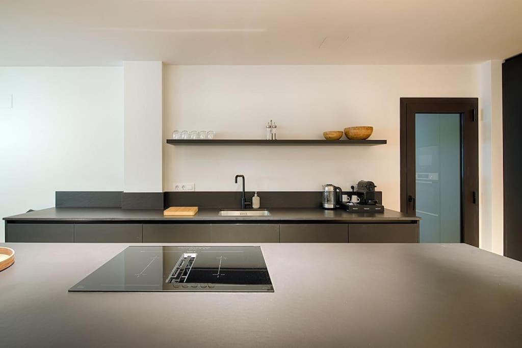 a kitchen with a sink and a counter top at Apartament Girona Center in Girona