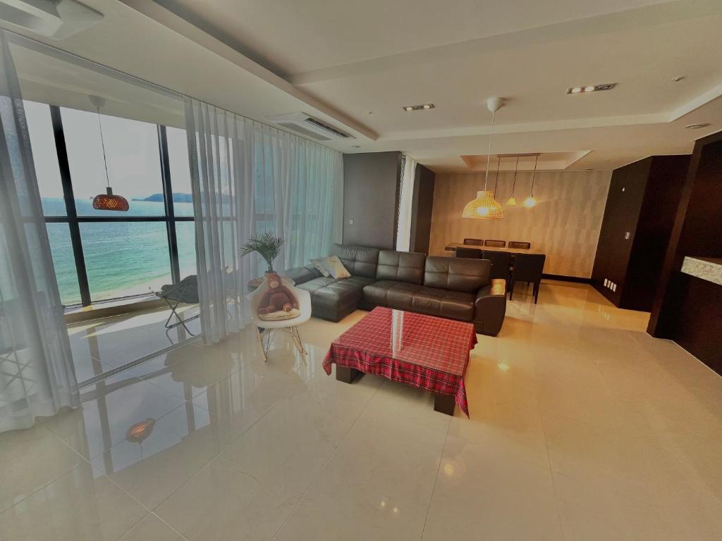 a living room with a couch and a table at Haeundae Luxury House in Busan