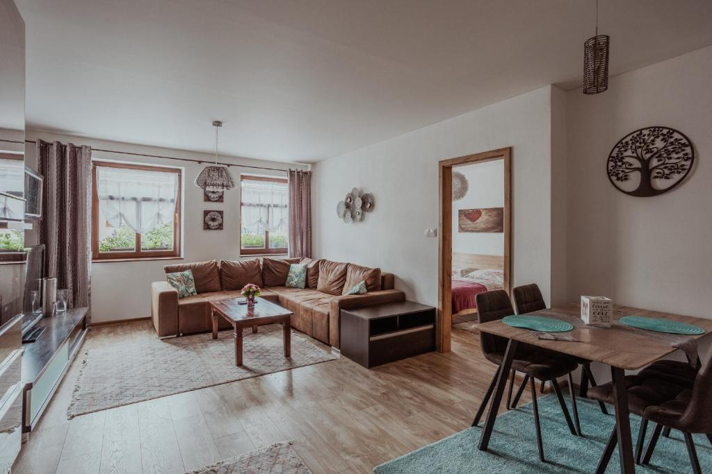 a living room with a couch and a table at Apartmány Starý trh in Kežmarok