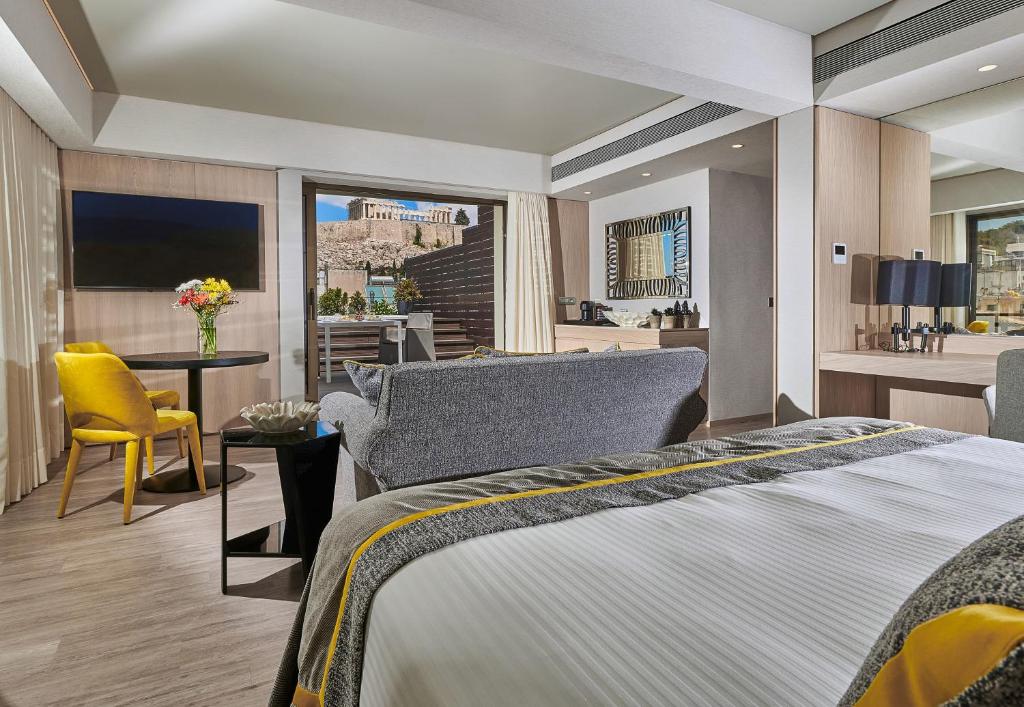 Postel nebo postele na pokoji v ubytování Divani Palace Acropolis