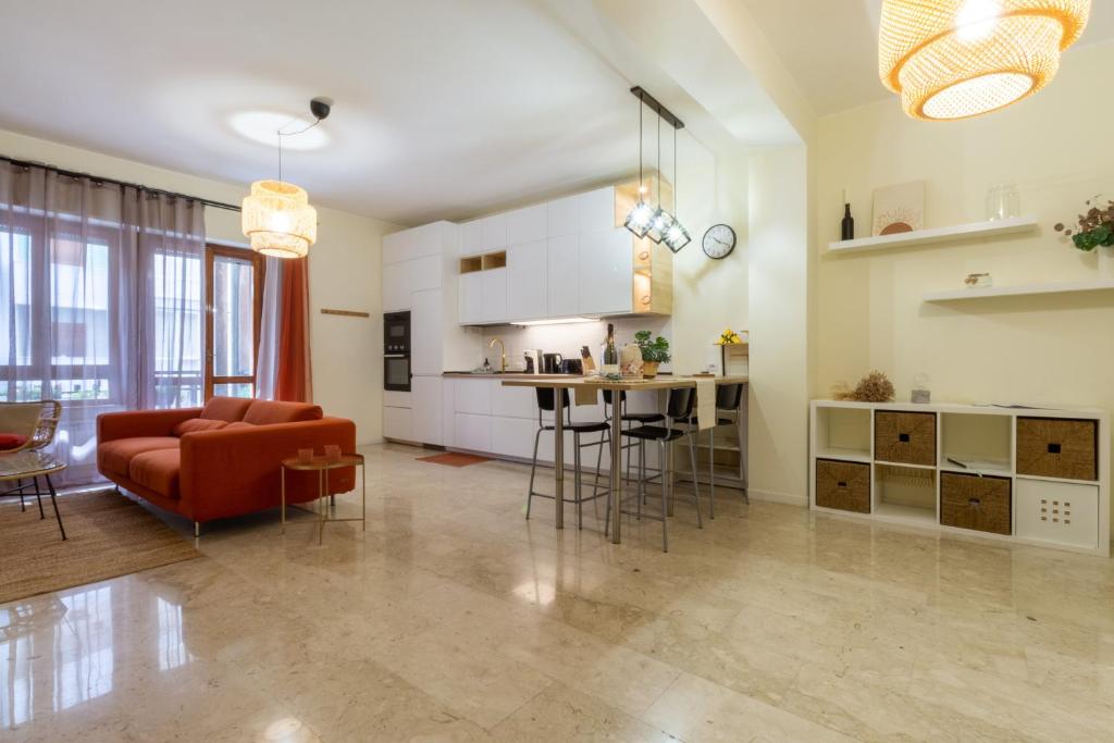 a living room and kitchen with a couch and a table at Sonnino House in Cagliari