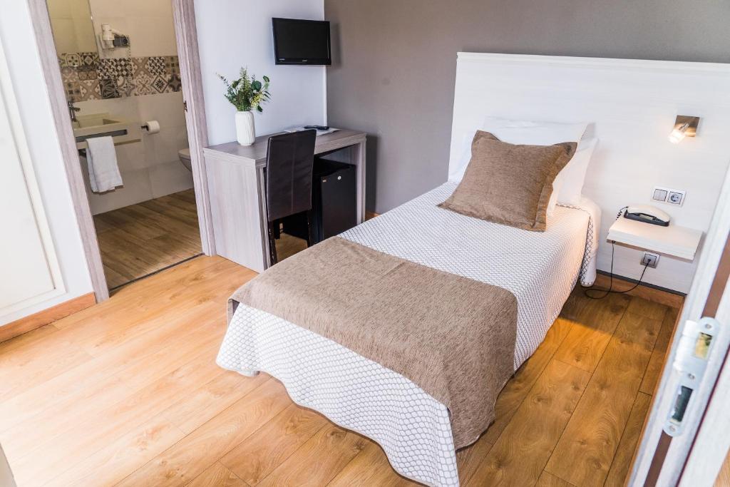 Posteľ alebo postele v izbe v ubytovaní Hotel Planas