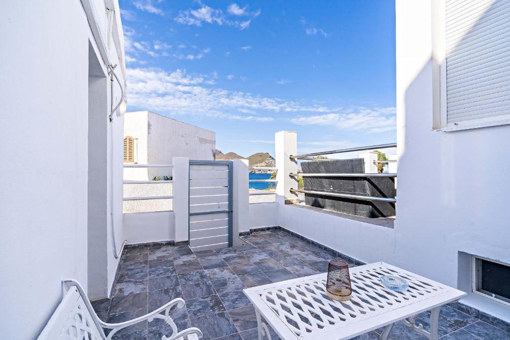 a balcony with a table and chairs on a building at Apartamentos Dulcemar Frente al Mar con zona SPA in San José