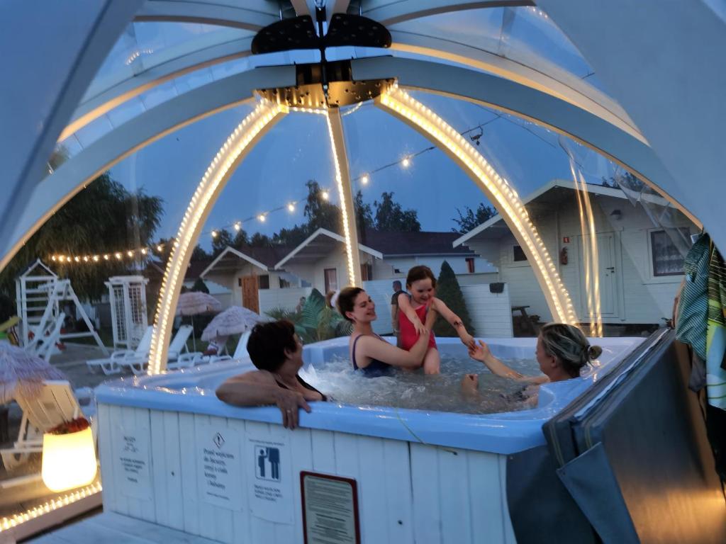 a group of people sitting in a hot tub at Pod Gruszą Wicie in Wicie