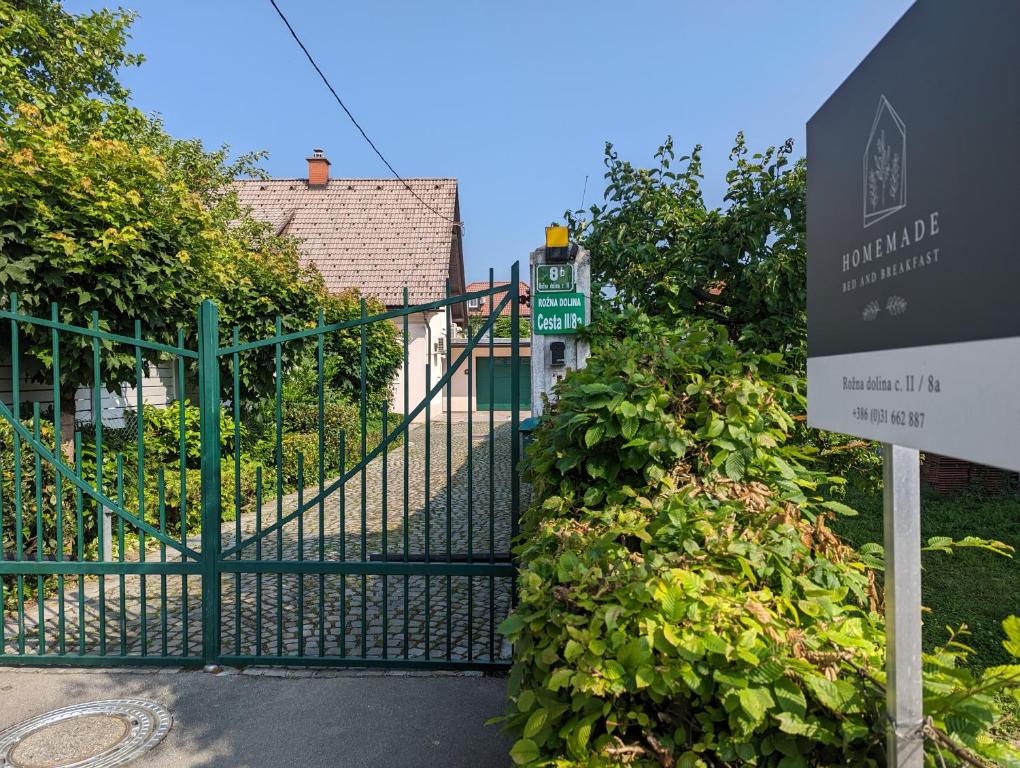 a gate with a sign in front of a building at HoMEMADE Bed and breakfast in Ljubljana