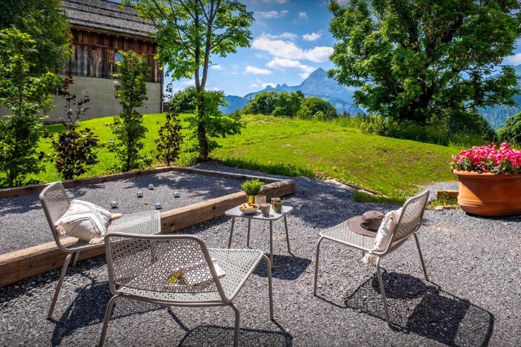 a patio with two chairs and a fire pit at Chalet Mevi - OVO Network in Crest-Voland