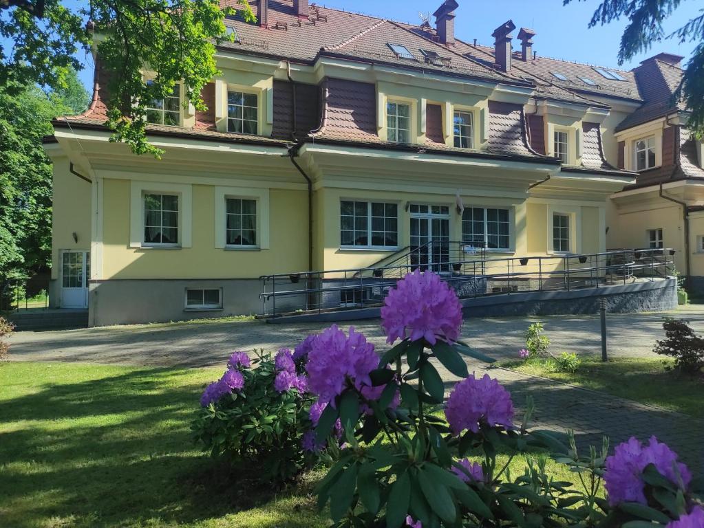 a house with purple flowers in front of it at Residence Park in Bielsko-Biała