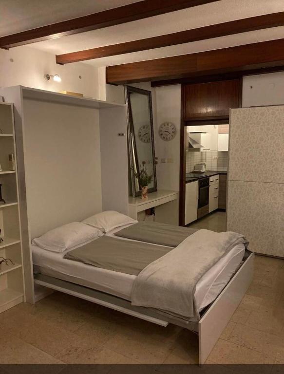 a bedroom with a large bed in a room at COSY APARTMENT FILIP IN THE HISTORICAL OLD TOWN in Koper