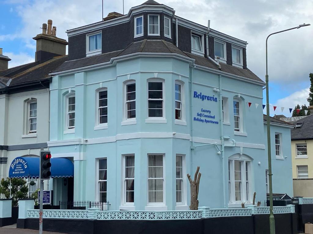 a blue building on the corner of a street at Belgravia Luxury Holiday Apartments in Torquay