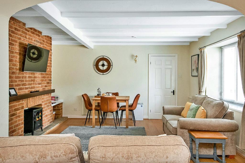 a living room with a couch and a table at Finest Retreats - Rosedale Hall Cottage in Thirsk