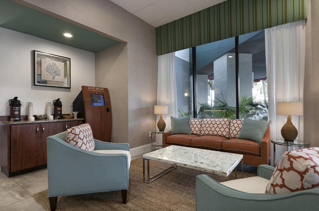 a living room with a couch and chairs and a table at The Strand - A Boutique Resort in Myrtle Beach