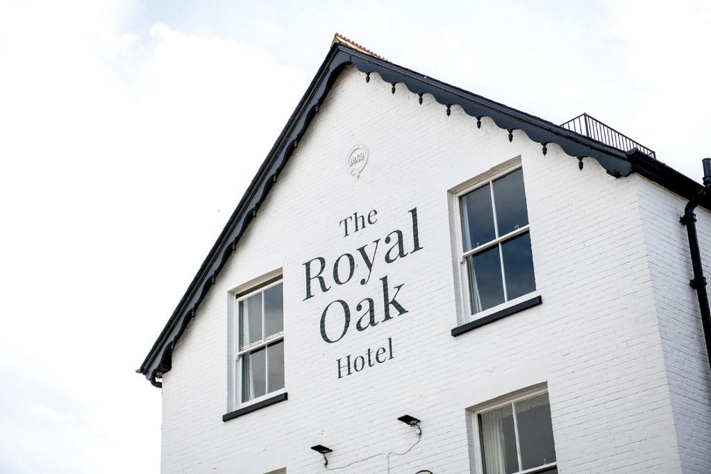 ein weißes Gebäude mit dem Schild des königlichen Eichenhotels in der Unterkunft The Royal Oak in Hawkhurst