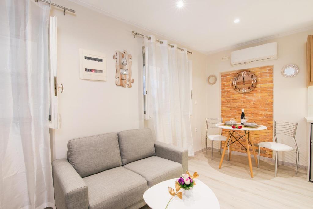 a living room with a couch and a table at Olimpias Nest Corfu in Corfu