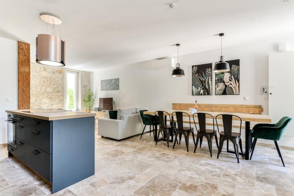 a kitchen and living room with a table and chairs at Grande villa de charme proche de la mer in Peyriac-de-Mer