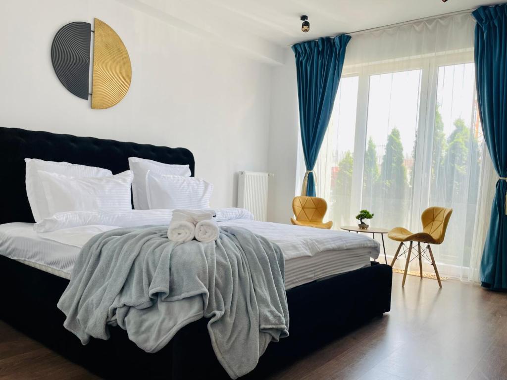 a bedroom with a bed with a bow on it at Aventurescu Studio Brasov Coresi in Braşov