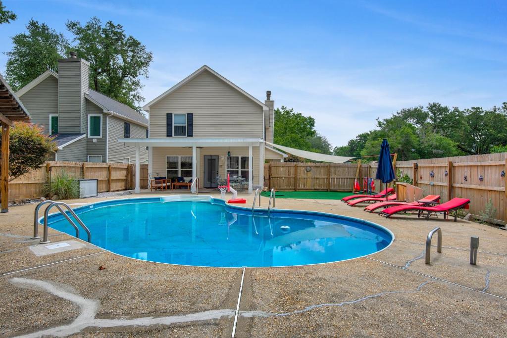 a swimming pool in front of a house at Private oasis, Pool, Downtown PNS & Beach 3BR-2,5BT in Pensacola