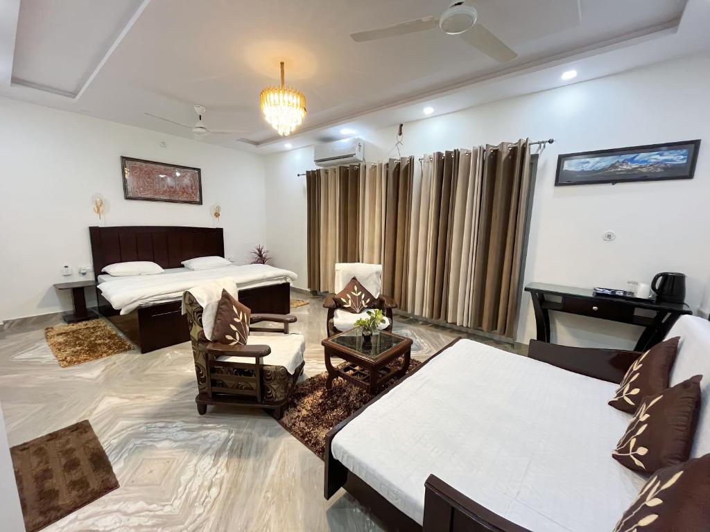 a living room with a bed and a couch at Alibaba’s Indiana Homestay in Tājganj