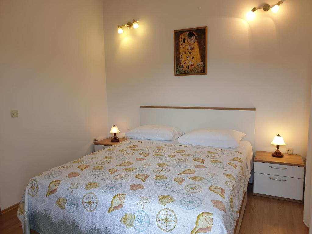 a bedroom with a large bed with two night stands at Seaview in Vrboska