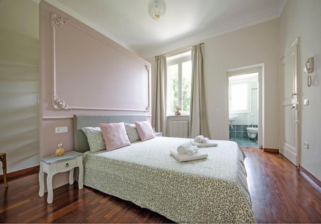 a white bedroom with a bed and a window at Bramante 21 in Pesaro