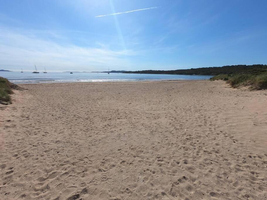 a sandy beach with the ocean in the background at Presqu&#39;ile de Giens - Hameau de la Pinede in Hyères