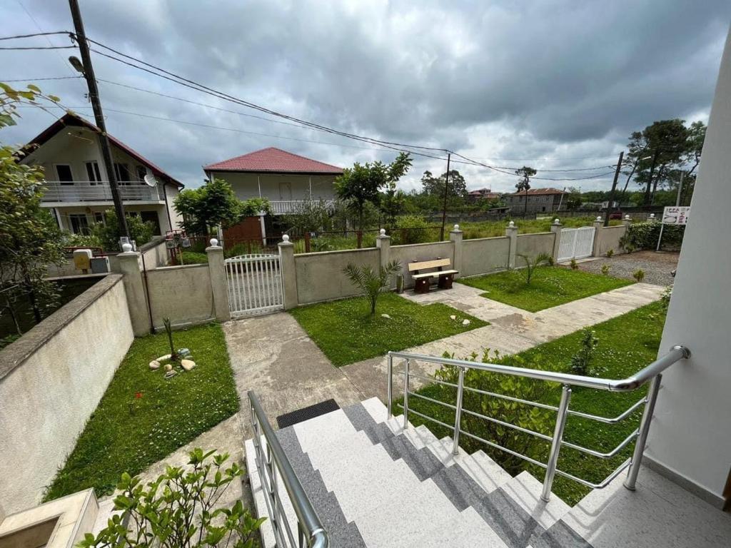 a backyard with a fence and a bench in a yard at IPPA S PLAZA in Grigoleti