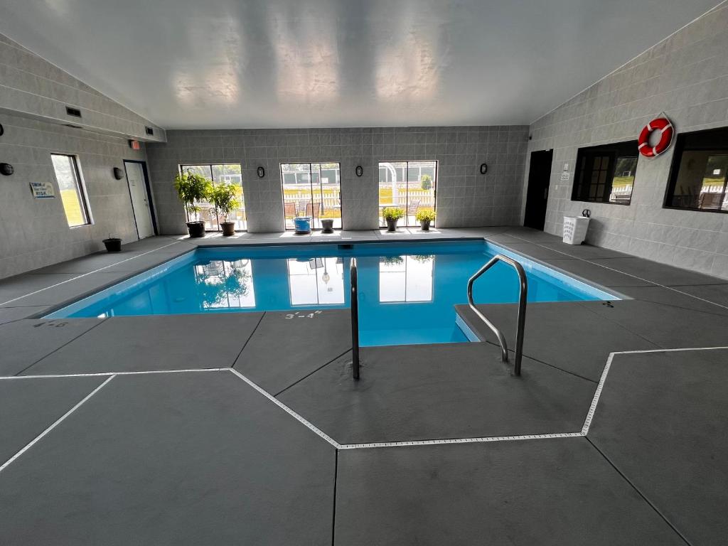 a large indoor swimming pool in a building at Sky Lodge Inn & Suites - Delavan in Delavan
