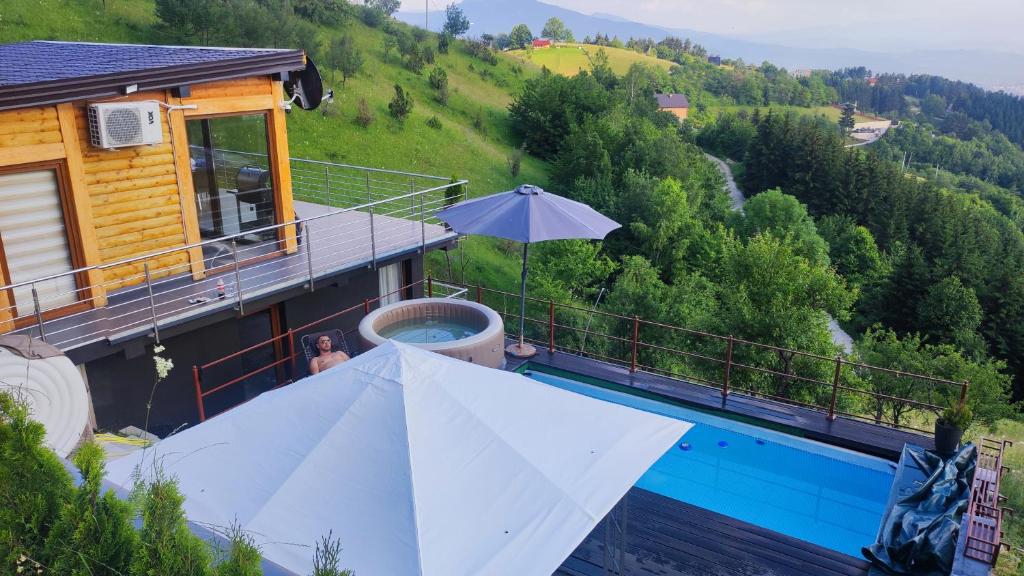 a villa with a swimming pool and a house at Villa unforgettable in Sarajevo