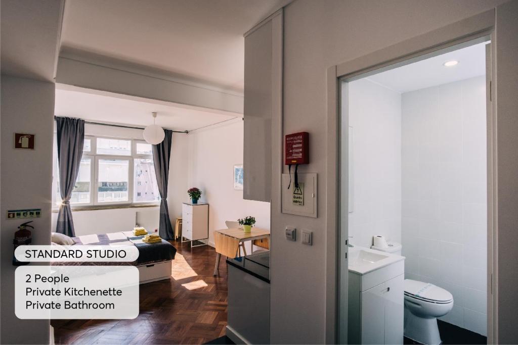 a bedroom with a bed and a bathroom at Studio 59 Lisboa in Lisbon
