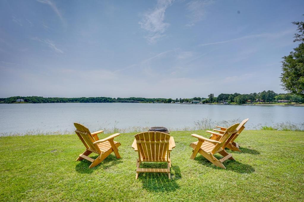 three chairs sitting on the grass next to a lake at Virginia Retreat on Wicomico River with Dock! in Reedville