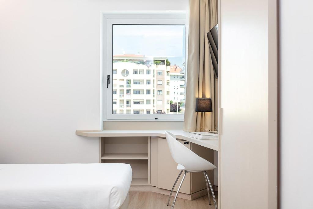 Łóżko lub łóżka w pokoju w obiekcie Hotel Carlo Felice Sassari