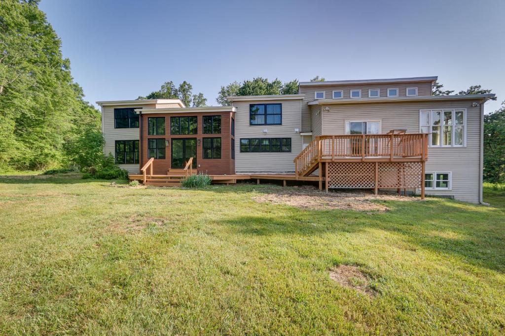 a large house with a large deck on a yard at Bright Bluemont Home with On-Site Pond and Mtn Views! in Paris