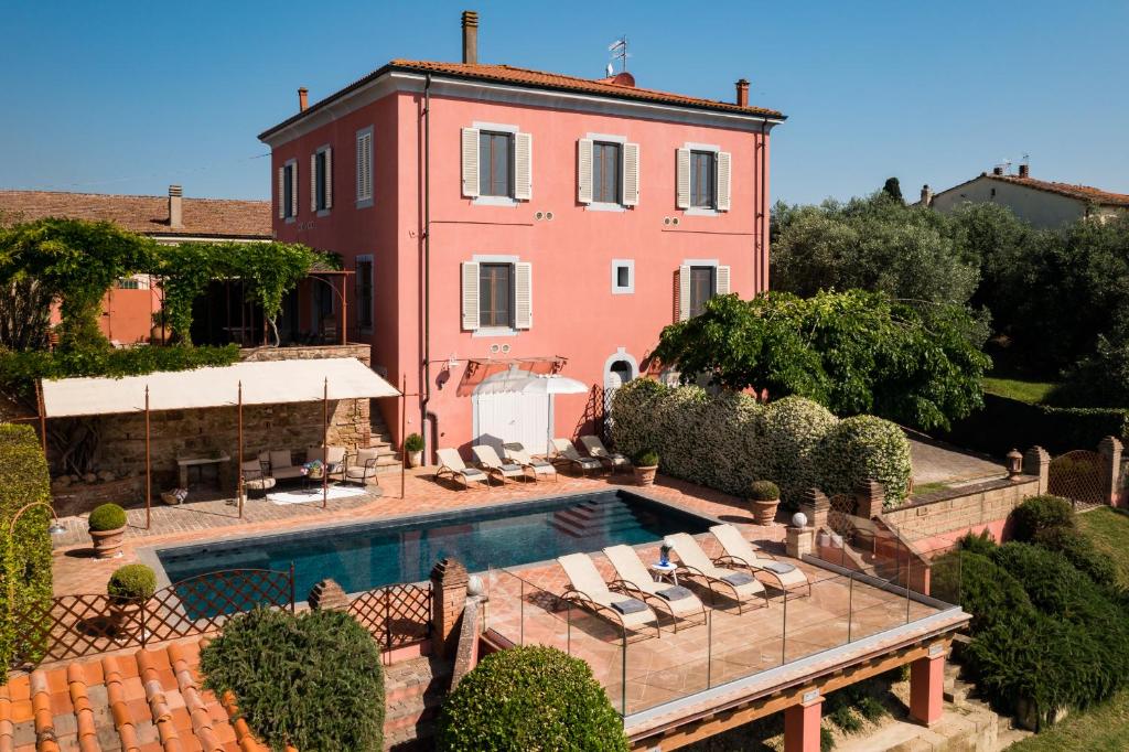 a house with a swimming pool in front of a house at Villa Angelica in Peccioli