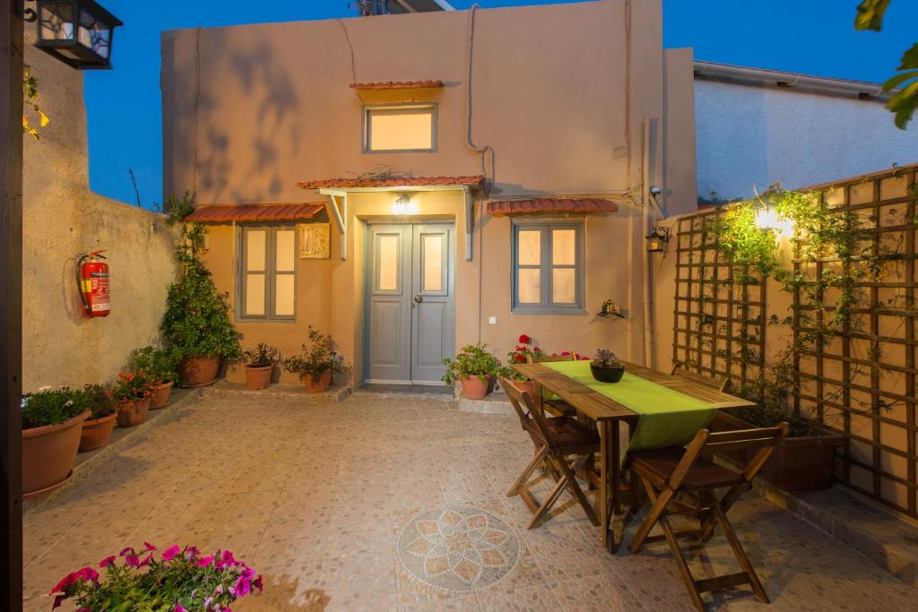 a patio with a table and chairs in front of a house at Muses-Old Town in Rhodes Town